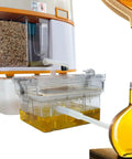 High Efficiency Automatic Edible Oil Filter Machine For Household Use with transparent cup and oil collection jug.