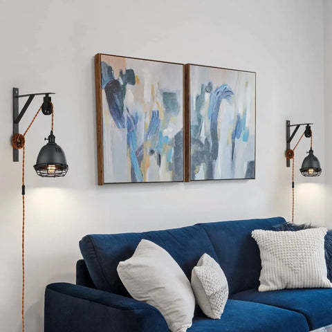 Living room with Vintage Industrial Wheel Pulley Wall Mount Lamp Set Of 2 With Plug In 7 Foot Brown Cord and blue sofa.