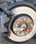 Zoomed view of a car brake rotor showing the placement of screws from the 16Pc Stainless Steel Car Brake Disc Rotor Screws Kit For Front And Rear Rotors Retaining Bolts And Hardware Auto Replacement Screws Set Heavy Duty Durable Automotive Accessories.