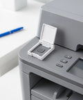 White hinged Safety Switch Protector Button Guard Cover on office printer