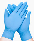 Hands wearing Blue Nitrile Exam Gloves Disposable Latex Free Non Sterile Medical And Food Safe Powder Free 100 Count Box Medium Size
