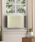 Legit Indoor Window Ac Cover That Keeps Your Setup Sharp And Shields Five To Seven Thousand Btu Units Fitting 21 By 15 By 3.5 Inches From Brisk Weather And Dust Builds Using Soft Washable Polyester In Crisp White, on an AC unit behind a window.