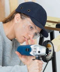 Woman using Heavy Duty Four Pack Of 4-1/2 Inch Wood Carving Discs With 7/8 Inch Arbor on 115Mm angle grinder.