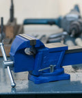 Beefy 4 Inch Bench Vise with Swivel Base and Anvil for Metalworking on workshop table