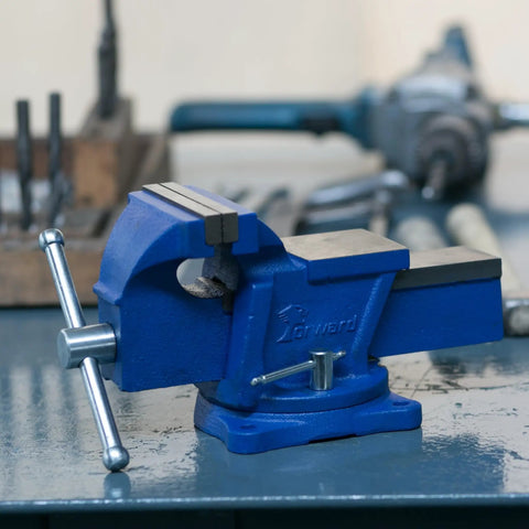 Beefy 4 Inch Bench Vise with Swivel Base and Anvil for Metalworking on workshop table