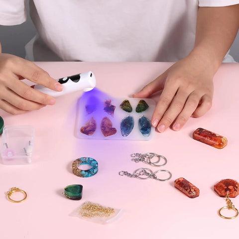 Person using UV light from All In One Resin Polishing Kit With Electric Rotary Drill And UV Light on resin crafts and jewelry