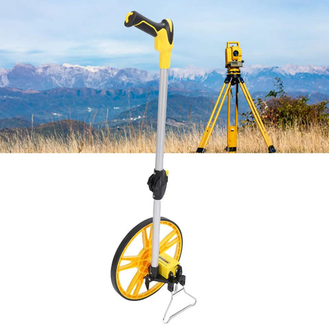 Dead On Accurate Mechanical Distance Measuring Wheel With Hella Tough Aluminum Alloy Build And Integrated Carry Handle For No Fuss Industrial Surveys Or Home Diy Projects Includes Top Shelf Travel Carrier positioned against mountainous landscape.