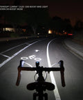 Lumina OLED Beast Mode Boost 1200 Bike Light illuminates dark road in boost mode, showing wide bike lane ahead at night