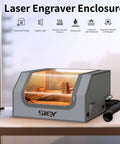 Front view of SKOY laser engraver enclosure in gray with LED light and vent hose