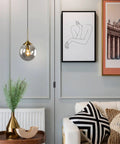 Mid Century Modern Brushed Gold Pendant Light With Plug In Cord, Smoke Gray Glass Globe in stylish living room setting