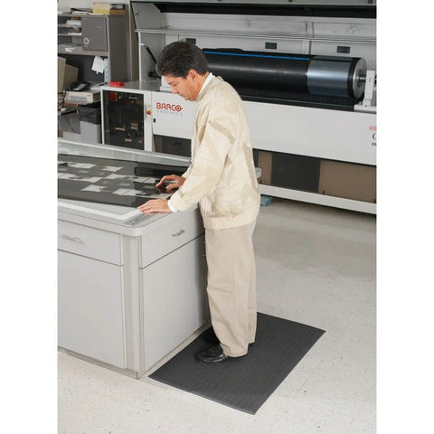 Person standing on Air Step Anti Fatigue Floor Mat Black 36 Inch Long 24 Inch Wide With Three Eighths Inch Vinyl Foam Cushioned Support