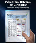 Framed Fluke Networks test certification poster held by a hand against a dark blue background.