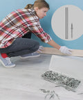 Woman installing baseboards using 250 Pack Double Headed Skirting Nails Made Of Premium Carbon Steel for a seamless look.