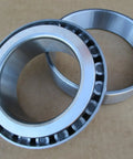Heavy Duty Replacement Tractor Bearing For Ih International 1066 1466 766 966 Farmall shiny steel bearing components on a brown background.