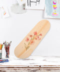 Blank Unfinished 7 Ply Wooden Skateboard Deck With Double Tail For Art Painting And Do It Yourself DIY Custom Builds Replacement Deck For Home Decor And Creative Projects, decorated with floral painting, displayed on a table.