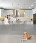 105 Inch Extra Wide Baby Gate For Large Openings Retractable 33 Inch Tall Indoor Outdoor Mesh Gate For Wide Doorways And Decks Kid Safe Pet Gate Grey Durable in a modern kitchen with a woman holding a child and a golden retriever