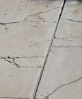 Concrete slab with visible cracks needing Slab Concrete Crack Repair Sealant Gray 10.5 Oz Cartridge Easy To Use Diy Friendly Kit.