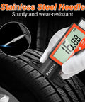 Digital Tire Tread Depth Gauge With Large LCD Display touching tire tread, showing 15.88 mm with stainless steel needle.