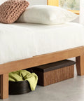 Queen Platform Bed Frame Low Profile Solid Pine Wood with storage baskets beneath for towels and linens.