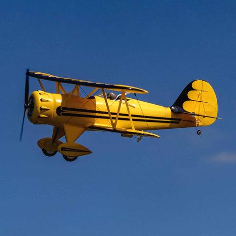 UMX Waco Yellow RC Airplane Bind-N-Fly BNF With AS3X And Safe Technology in flight against blue sky