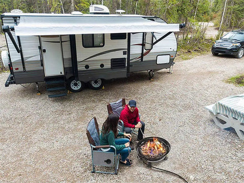 Couple using No Mess Smokeless Round Propane Fire Pit For Outdoors With Durable Weather Resistant Cover at RV site