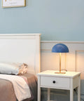 Blue Desk Lamp With Brass Accents, 15 Inch Modern Mushroom Shade on nightstand in cozy bedroom setting, LED Bulb Compatible