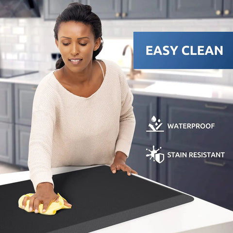 Person cleaning black Anti Fatigue Kitchen Mat Cushioned Comfort Rug For Standing Desk And Floor Water Resistant Non Slip Pad With Thick Foam Support