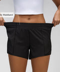 Elastic waistband on Women's Low Rise Running Shorts With Mesh Lined Built-In Liner, Quick Dry Workout Short in black.