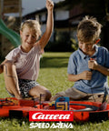 Kids playing with Speed Arena Disney Pixar Cars Slot Car Race Track Set With Lightning McQueen And Dinoco Cruz Ramirez outdoors.