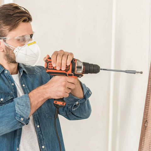 Person using a drill with Four Piece Quarter Inch Spade Drill Bit Extension Set With Hex Shanks for hard-to-reach areas