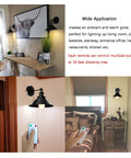 Two Pack Black Swing Arm Wall Sconces With Remote Control Cordless Battery Powered LED Wall Lamps in living room settings