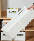 Adjustable Sliding Drawer Organizer With Telescopic Length For Kitchen And Office Seamless Expandable Closet Storage To Lock Down The Clutter and Keep Your Setup Fire, white storage box being held.