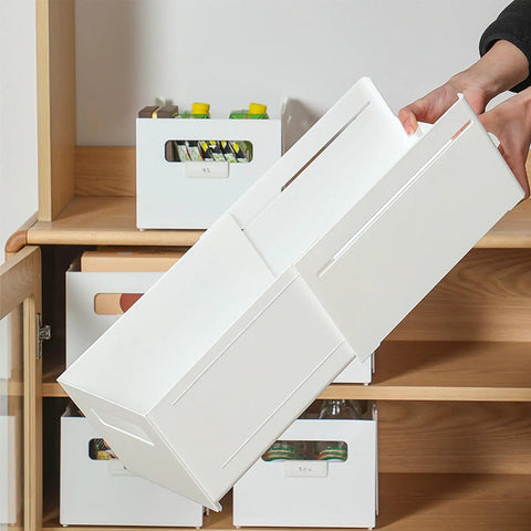 Adjustable Sliding Drawer Organizer With Telescopic Length For Kitchen And Office Seamless Expandable Closet Storage To Lock Down The Clutter and Keep Your Setup Fire, white storage box being held.