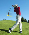 Golfer using Indoor Golf Swing Trainer Aid With Weighted Head And Flexible Shaft For Tempo, Grip Strength, And Flexibility Training, 48 Inch Yellow.