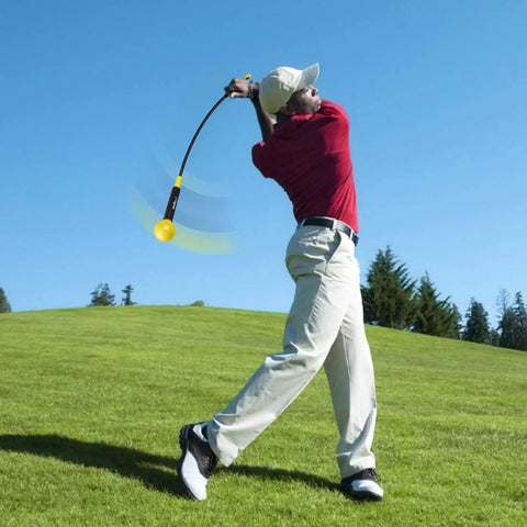 Golfer using Indoor Golf Swing Trainer Aid With Weighted Head And Flexible Shaft For Tempo, Grip Strength, And Flexibility Training, 48 Inch Yellow.