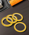 Four Pack Yellow Heat Resistant Paper Tape Featuring A Dang Tough Hold That Takes The Heat Without Breaking A Sweat arranged on a dark surface.