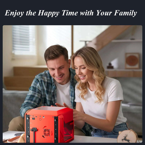 Red compact desktop laser engraver on a table, with a smiling couple using it.