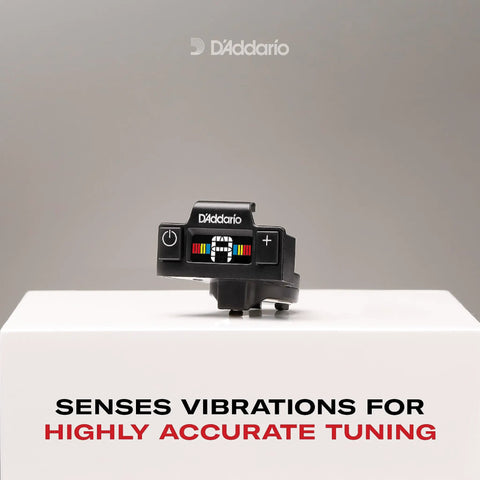 Close-up of Soundhole Clip On Tuner for Acoustic Guitars and Ukuleles with piezo sensor, on a white surface.