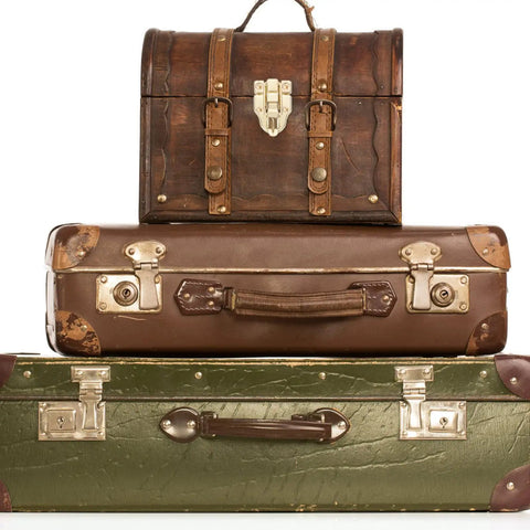 Stack of vintage suitcases with visible retro cabinet duckbilled toggle hasp and antique padlock