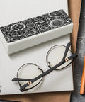 Industrial Metal Gear Textured Leather Eyeglass Case With Heavy Duty Magnetic Closure and Ultra Soft Velvet Lining for Prescription Glasses and Shades on notebook