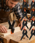 Man using Eight Pack Spring Clamps For Backdrops And Studio Setups, Heavy Duty Plastic Clips 2.7 Inch Background Clamps For Photography.
