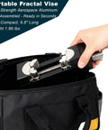 Hand placing a portable fractal vise into a black carrying bag, showcasing a 6.8-inch length compact tool.