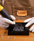 Person using Heavy Duty Handheld Engraver Pen With 24 Watt Motor And Dead Simple Speed Dial on black surface engraving design.