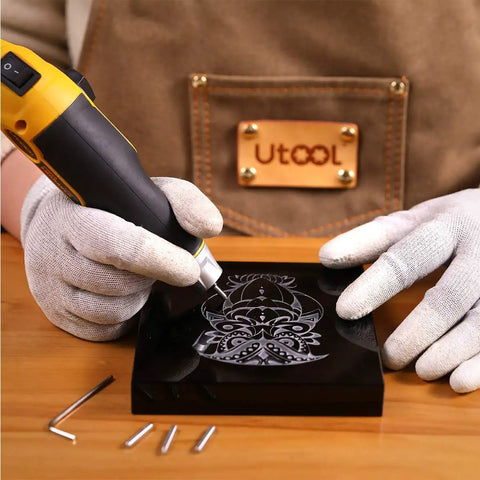 Person using Heavy Duty Handheld Engraver Pen With 24 Watt Motor And Dead Simple Speed Dial on black surface engraving design.