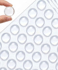 Hand holding a half inch clear silicone cabinet bumper pad from the 256 Piece Bulk Pack Clear Silicone Cabinet Door Bumpers Sticks Like Glue.