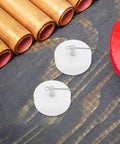 Two of the Four Pack White Nylon Furniture Casters Wheels For Drawers And File Cabinets No Squeak Glide shown on table