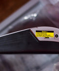 Side view of Pro Grade PT 2700 Desktop Labeling System with power port and notice label, silver and black design.