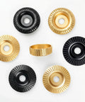 7 Piece Angle Grinder Wood Carving Disc Set For Four Inch Or Four And A Half Inch Grinders With Five Eighth Inch Arbor includes gold and black discs.