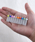 Hand holding 50Pcs PCB Drill Bits Set 0.3mm-1.2mm Carbide Micro Drill Bits For Circuit Boards Engraving CNC Jewelry
