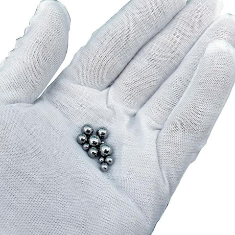 Hand holding 900 Piece Stainless Steel Precision Balls Set With Size Assortment One Quarter Inch Seven Thirty Seconds Inch